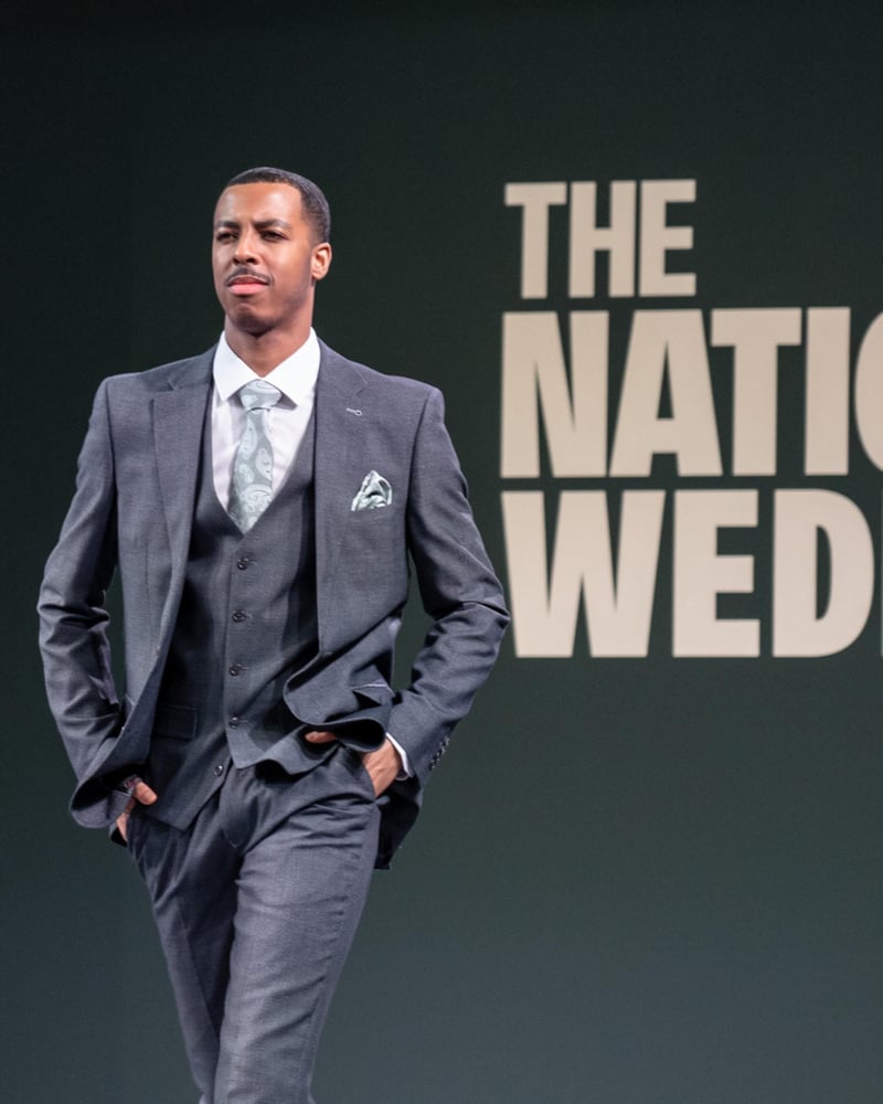 a male model in a suit on the national wedding show catwalk.