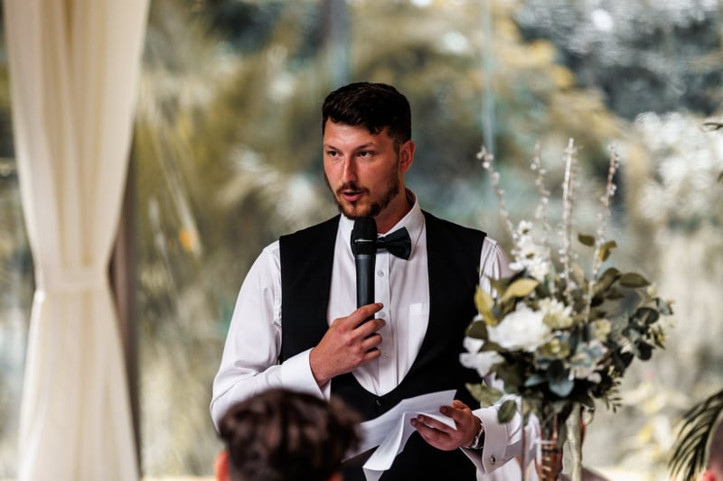 a best man standing and giving a wedding speech.