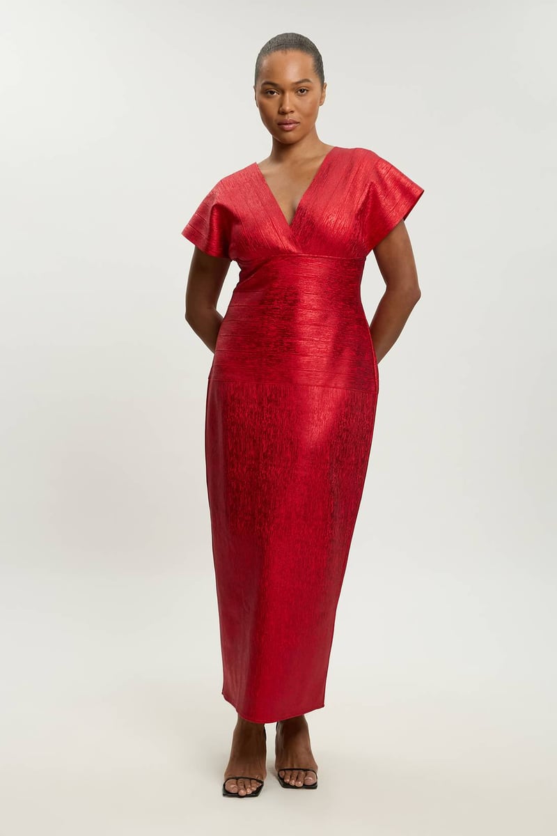 a plus size model wears a red foil metallic knit midi dress with v-neck.
