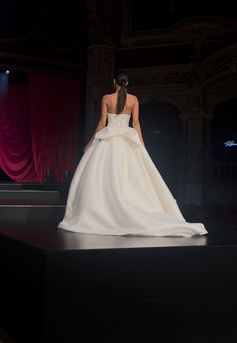 Full-skirted wedding dress with a bow detail at the back