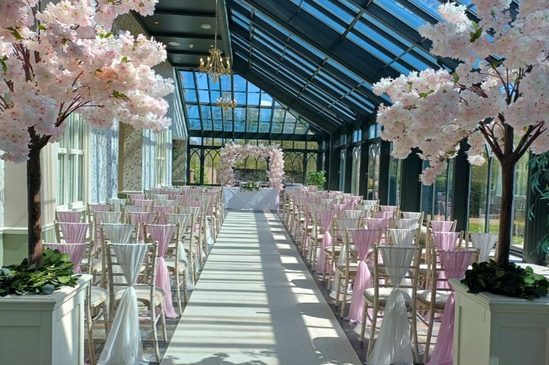 pink and white wedding ceremony with cherry blossom trees