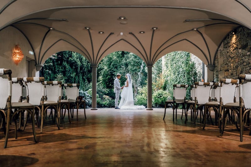 Couple under the vaulted garden arches at Whitworth Hall wedding venue