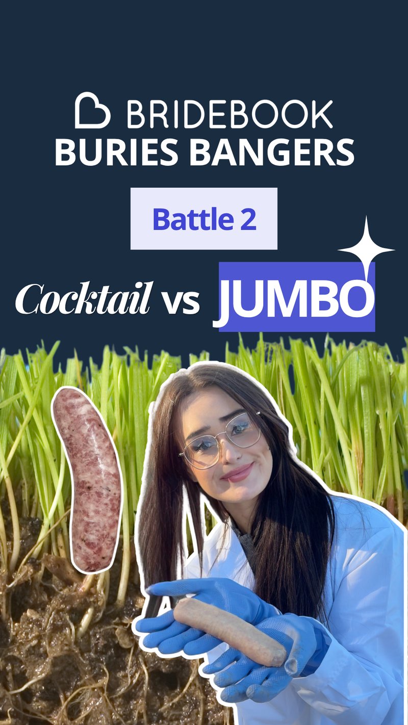 Lucy in a white coat and blue gloves holding a jumbo sausage