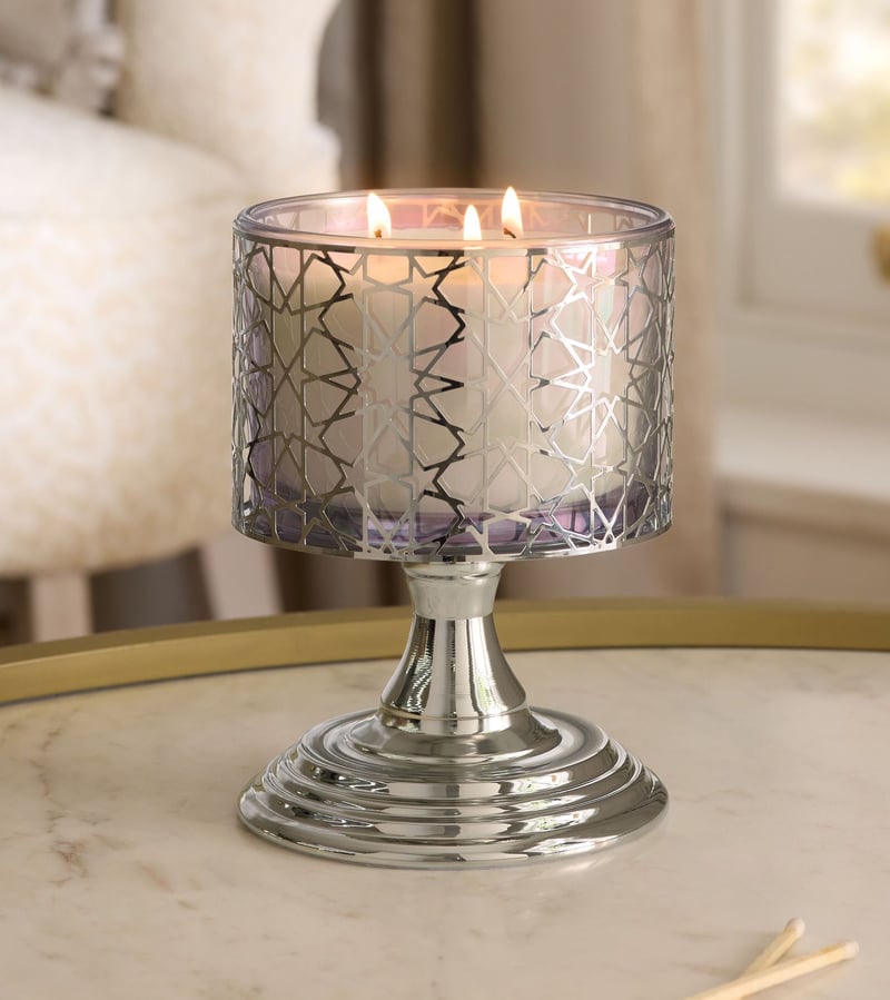 a silver star-print glass candle designed to look like a silver goblet.