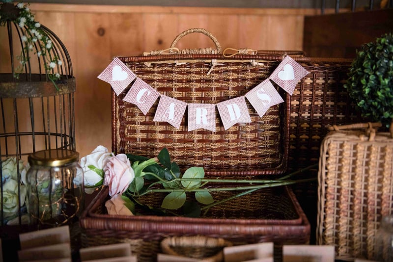 an open wicker card box at a wedding.