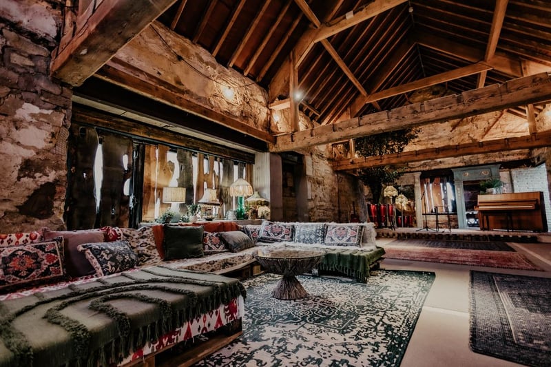 Rustic barn lounge with boho cushions and rugs at Solara Shores wedding venue