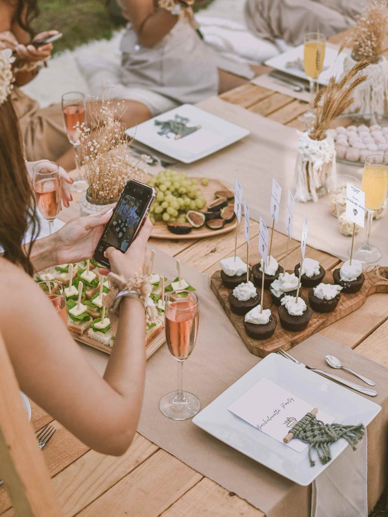 A maid of honour taking a photo of decor on a hen do