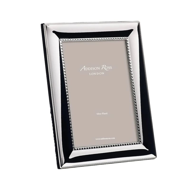 a silver photo frame with beaded detail.