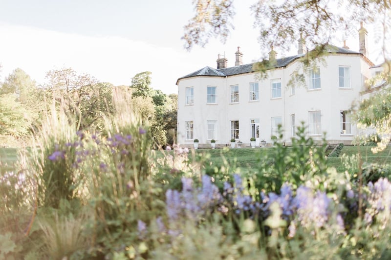 Lartington Hall country house wedding venue seen through a wildflower garden