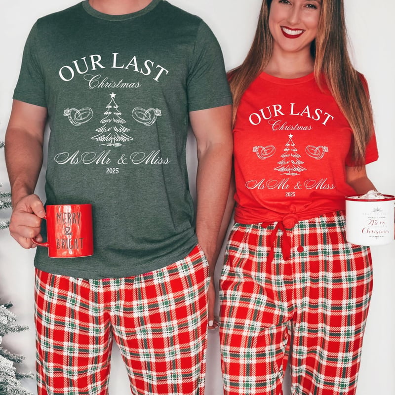 a man and woman in matching pyjamas holding mugs and smiling into the camera.