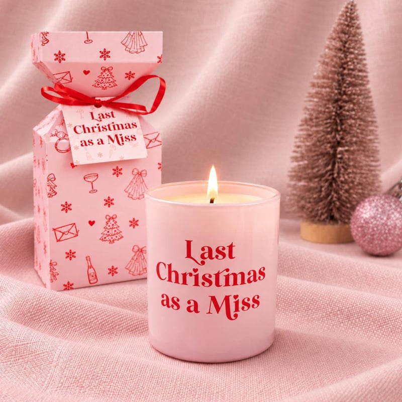 a 'Last Christmas as a Miss' slogan candle in pink on a pink background.