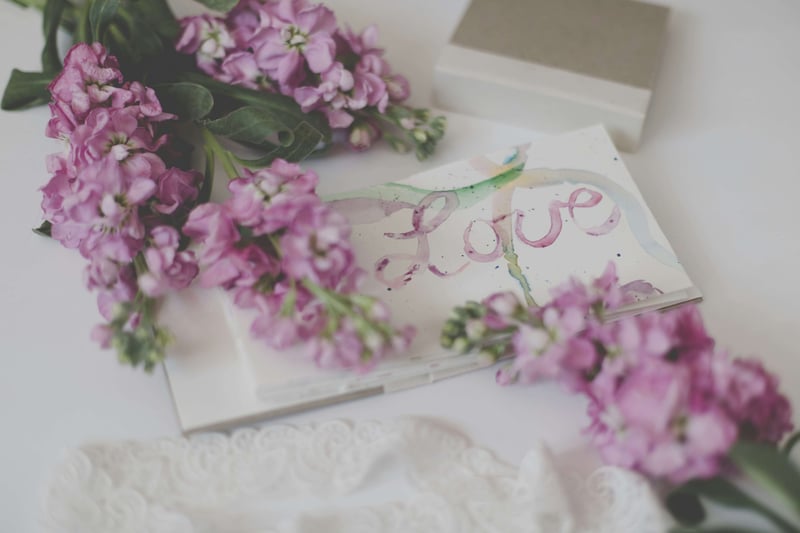 a love card next to some purple hyacinths.
