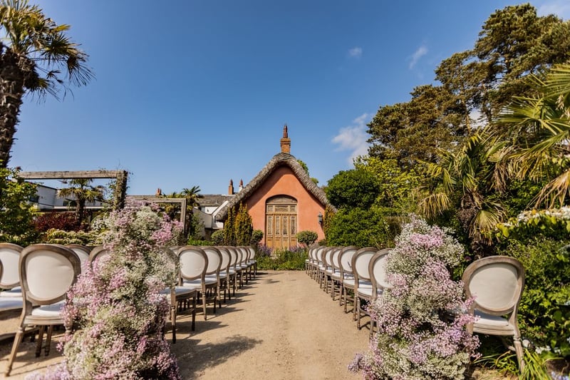 Outdoor ceremony aisle with pink gypsophila at Le Petit Château wedding venue