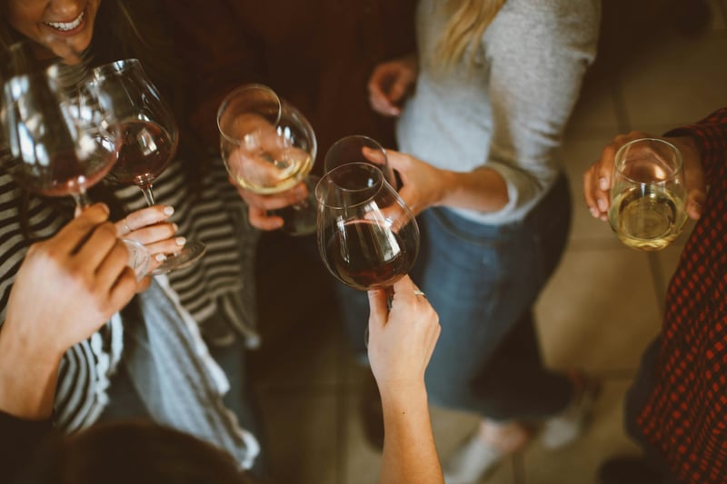 Women cheersing wine glasses on a hen do