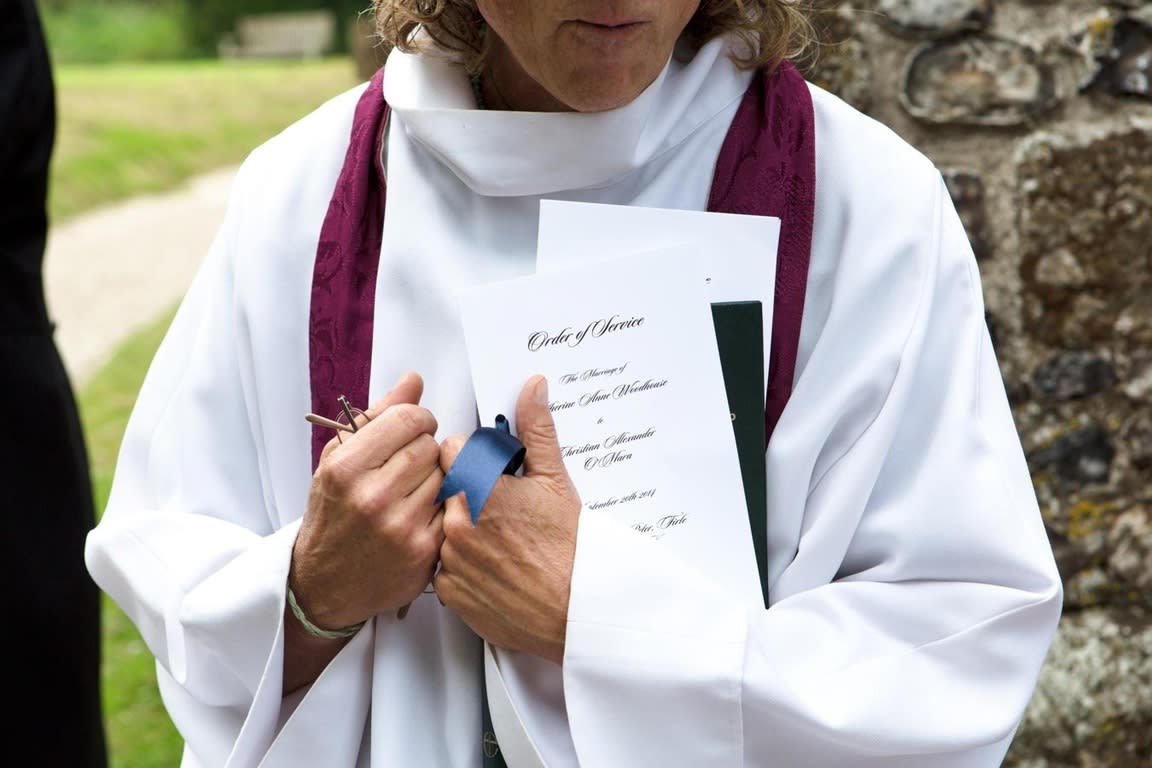 Bridebook.co.uk- minister holding traditional order of service