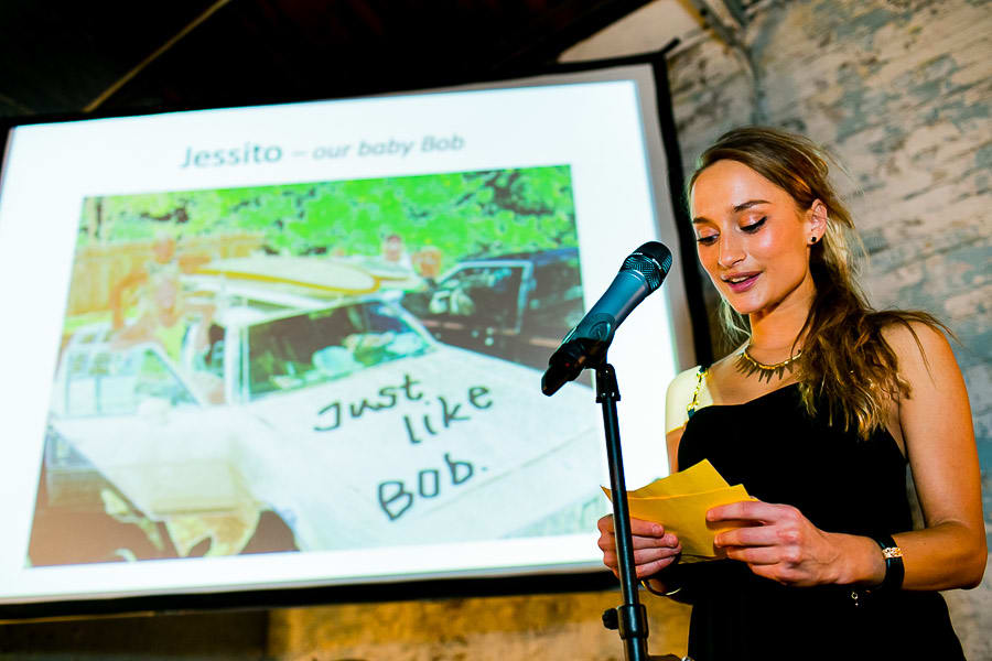 Bridebook.co.uk- maid of honour giving speech with projector in the background