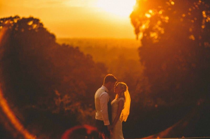 Bridebook.co.uk- bride and groom against the sunset