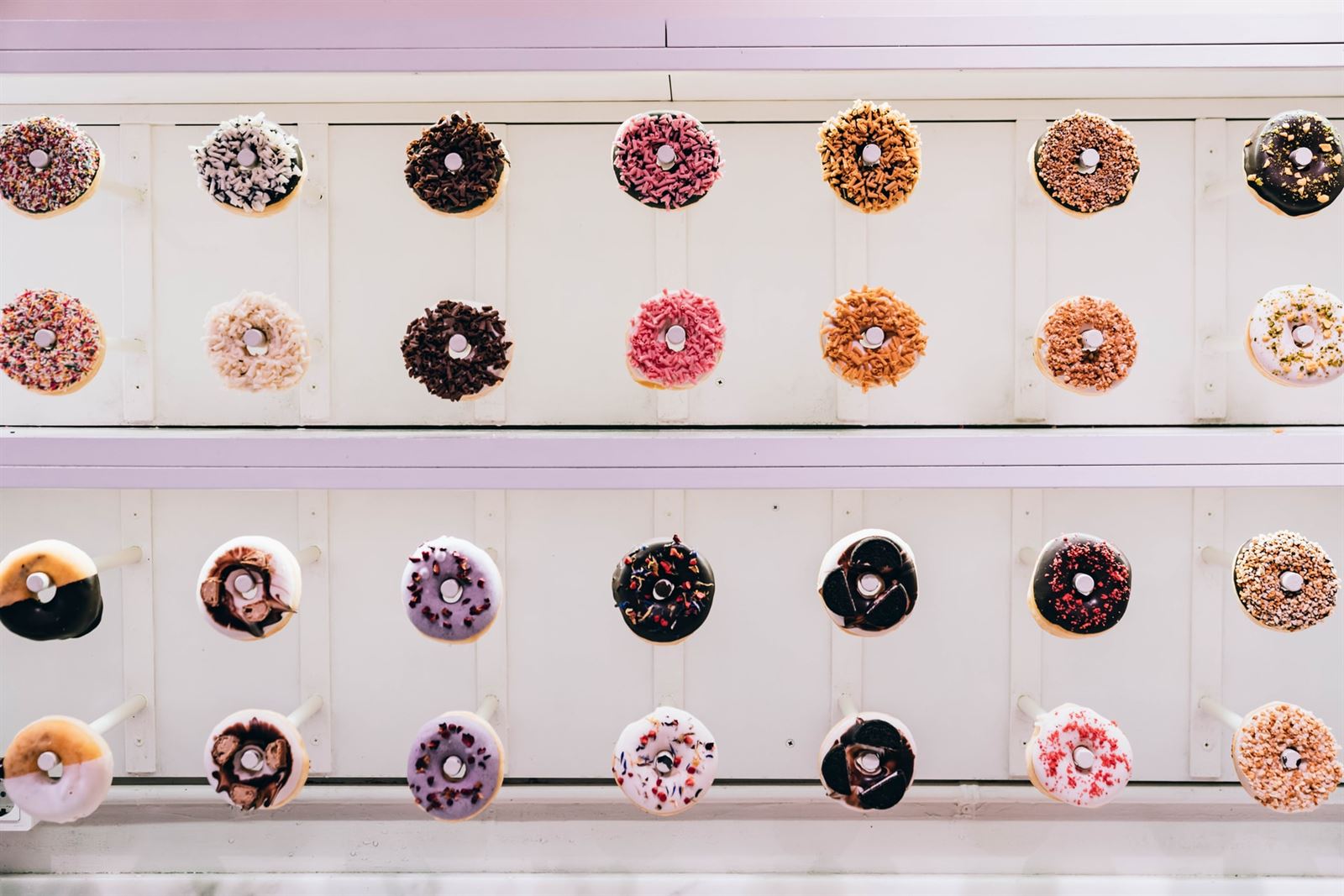 Doughnut wall holding plenty of  tasty doughnuts of different flavours at wedding