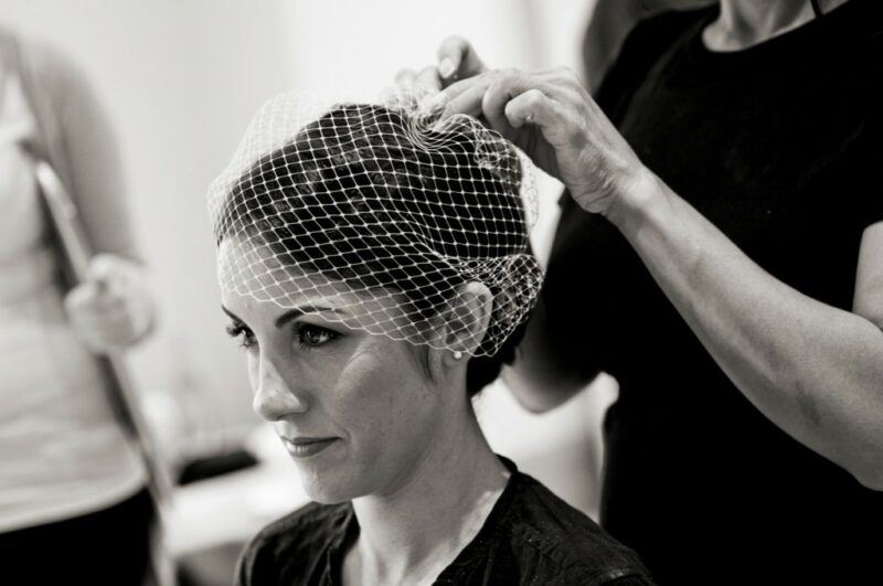 Bridebook.co.uk- bride having her birdcage veil put on