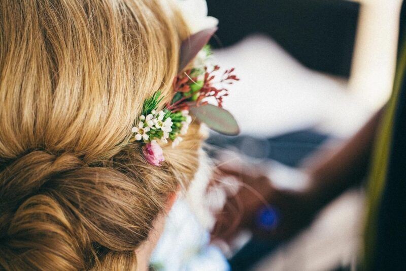 Bridebook.co.uk- close up of bridal hair with flowers decorating it