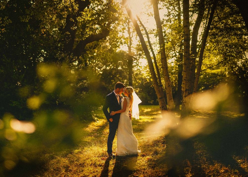 Bridebook.co.uk- bride and groom hugging in a forest