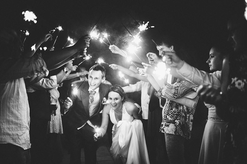 Bridebook.co.uk- Bride and groom walking under sparklers