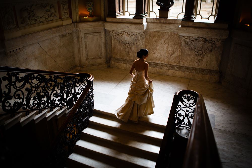 Bridebook.co.uk- bride walking up grand staircase
