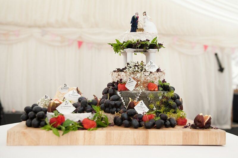 Bridebook.co.uk- cheese cake decorated with grapes and topped up with bride and groom figurines