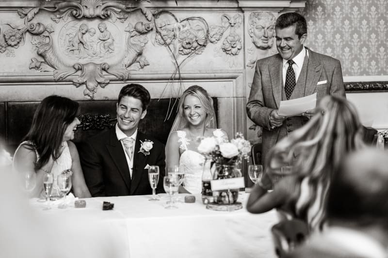 Bridebook.com - father giving speech as groom bride and mother laugh