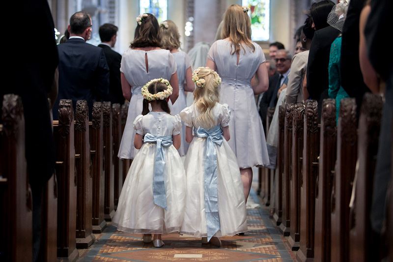 Bridebook.co.uk- flower girls walking behind bridesmaids