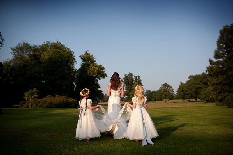 Bridebook.co.uk- flower girls carrying brides train