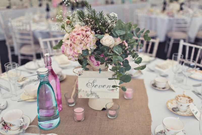 Bridebook.co.uk- table setting and name with flowers