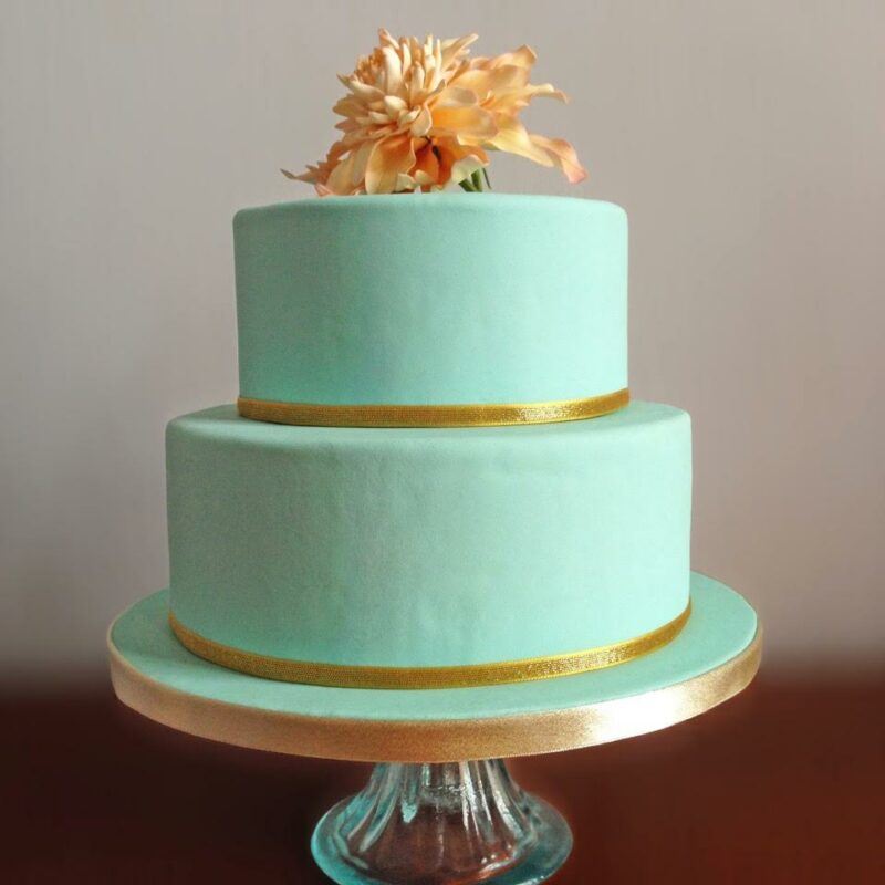 Bridebook.co.uk- mint green wedding cake decorated with a fantasy flower