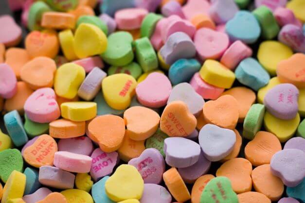 Mixed yellow, orange, green and purple love heart sweets