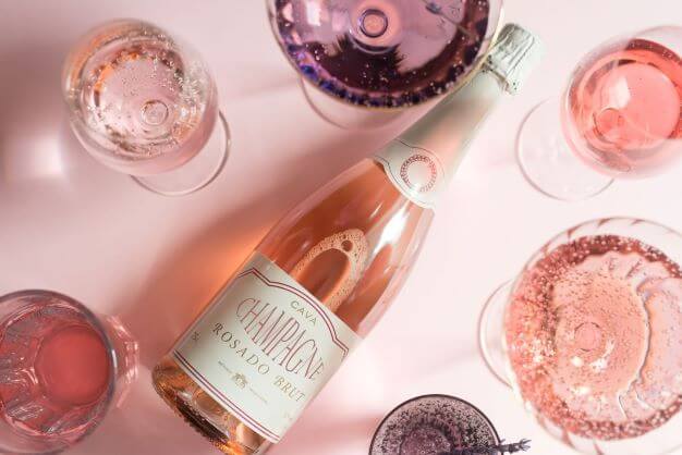 Flat-lay of a pink champagne bottle and glasses