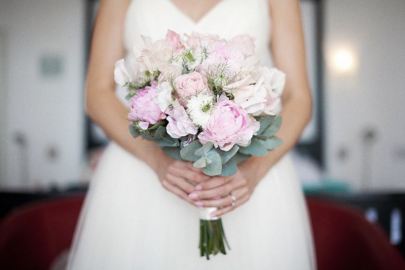 Bridebook.co.uk- Bride holding up pink and white bouquet