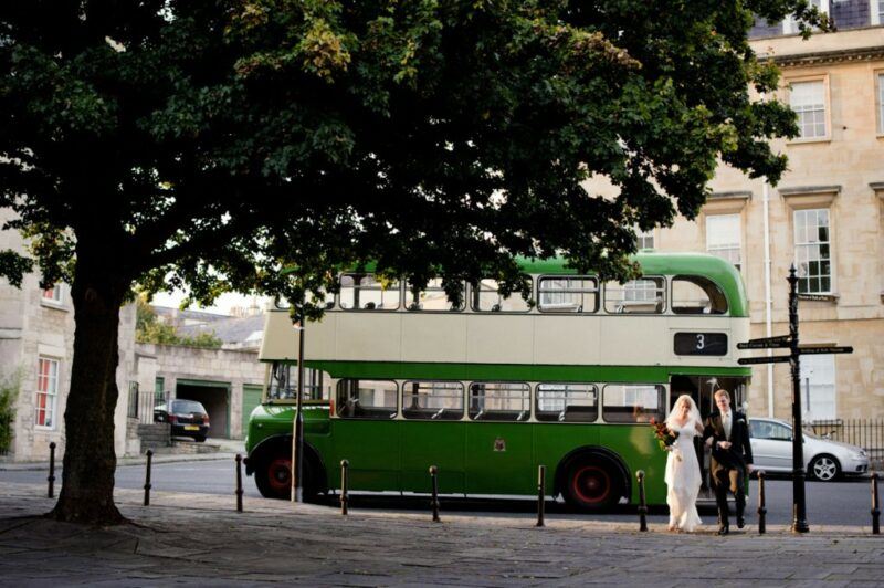 Bridebook.co.uk- bride and groom with green london bus
