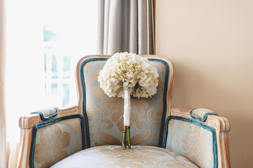 Bridebook.co.uk- white flower wedding bouquet on a chair