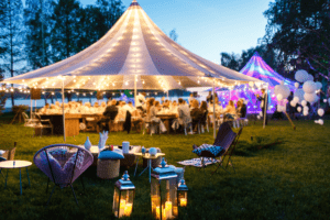 Wedding marquee at night with beautiful rainbow lights and lanterns