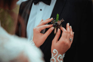 Bride adjusting groom's boutonniere