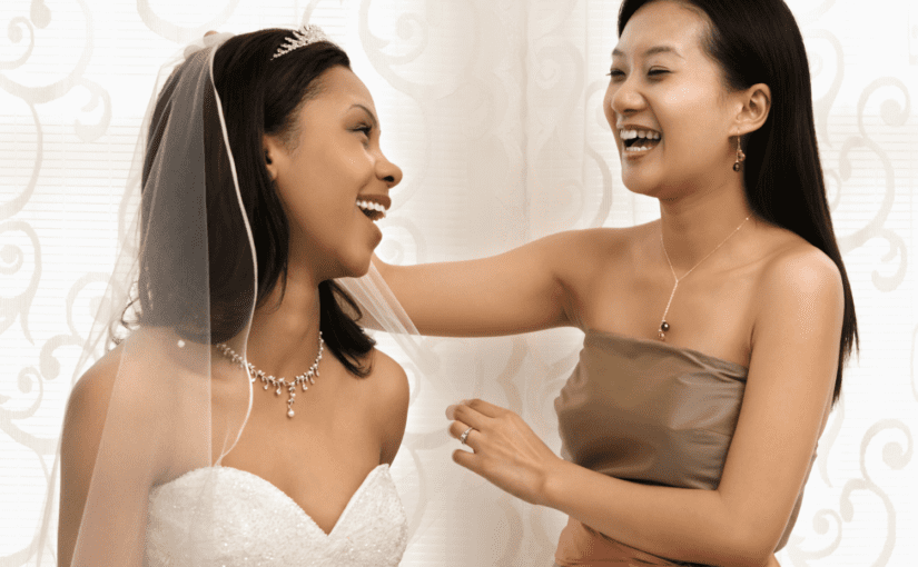Bride sharing excitement with maid of honour on wedding day
