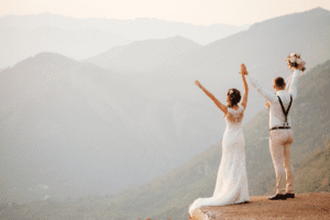 Bride and groom standing on an amazing mountaintop