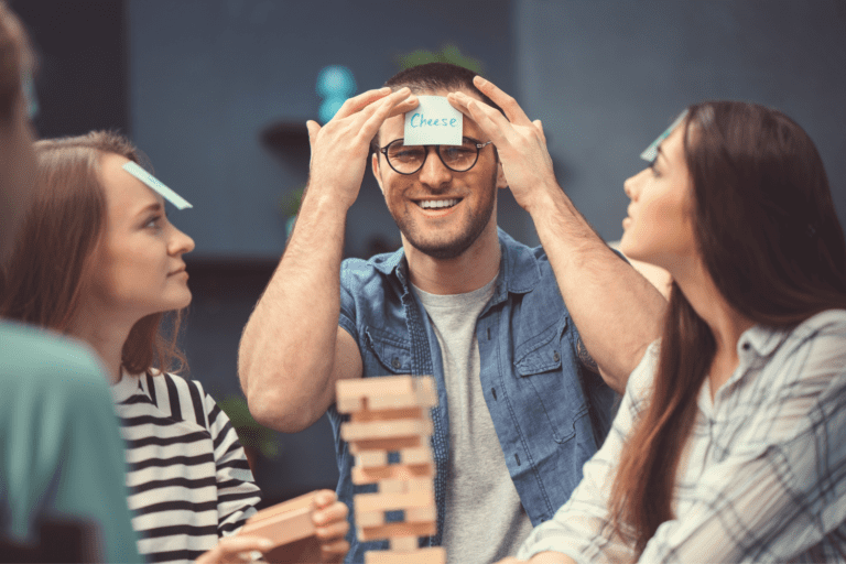 Friends playing games including code names and jenga