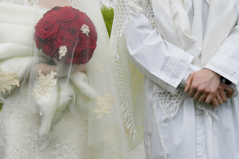 Traditional Jewish wedding couple wearing white