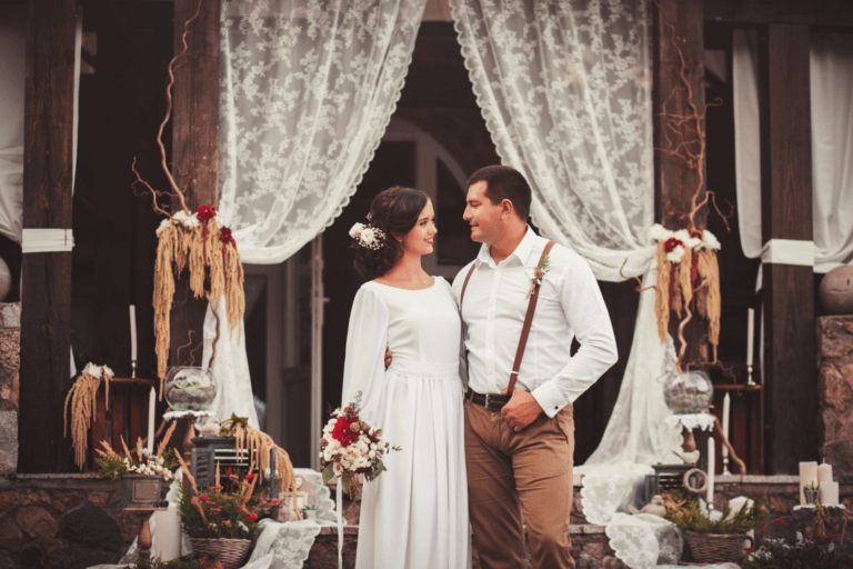 Rustic barn wedding with bride and groom wearing warm outfits 