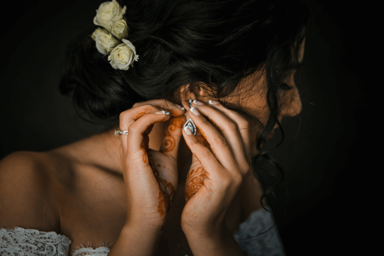 Indian bride getting ready and putting on earrings 
