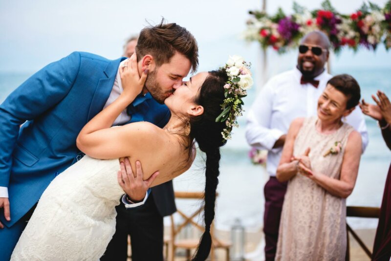 Married couple kissing on a beach