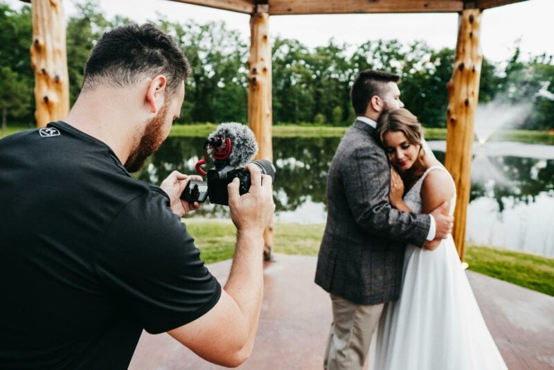 Wedding videographer filming a couple