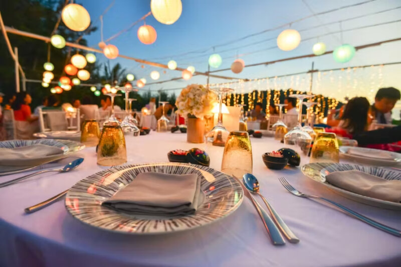 Evening dinner for a wedding with decorative lights