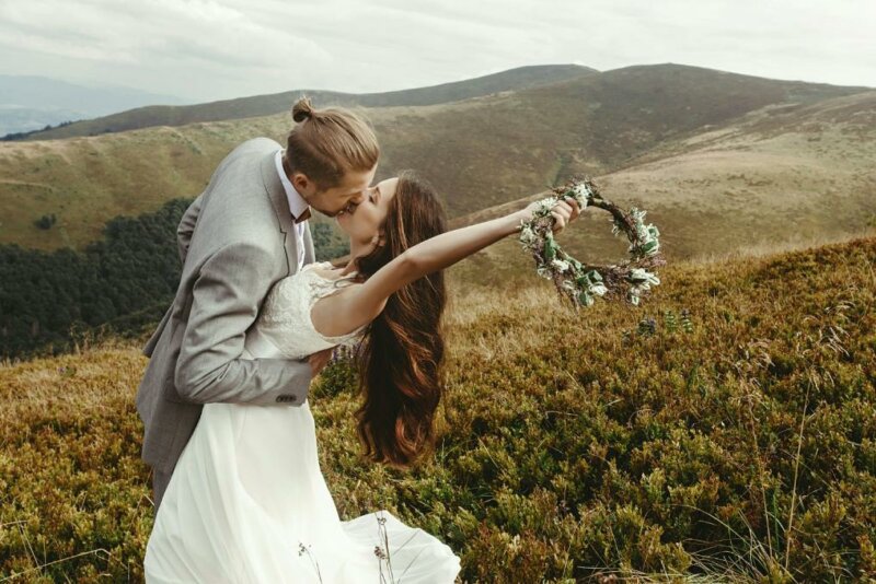 Married couple kissing in a field